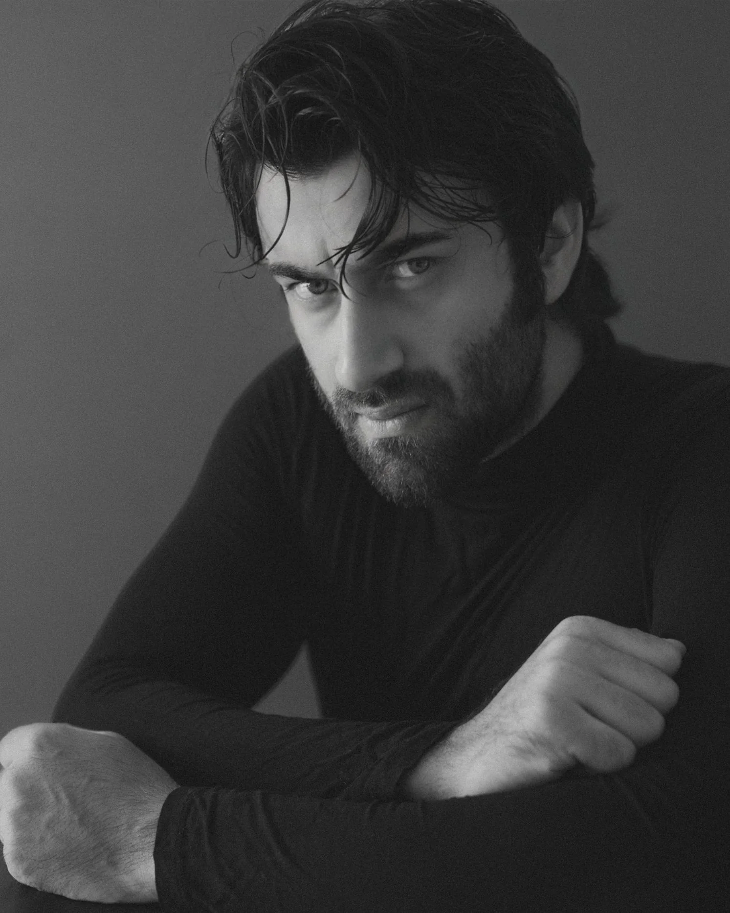 Black and white portrait of Rohed Khan in a dark jacket